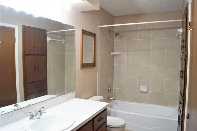 Bathroom featuring vanity and shower combination | Image 9
