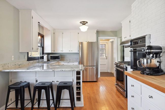 Charming kitchen with peninsula style breakfast counter | Image 9