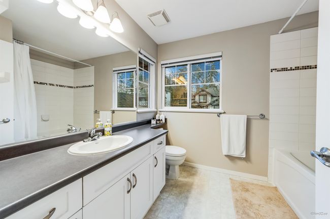 Full bathroom featuring visible vents, toilet, vanity, and shower / bath combination with curtain | Image 16