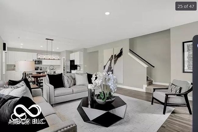 Living area featuring stairway, recessed lighting, baseboards and wood finished floors | Image 9