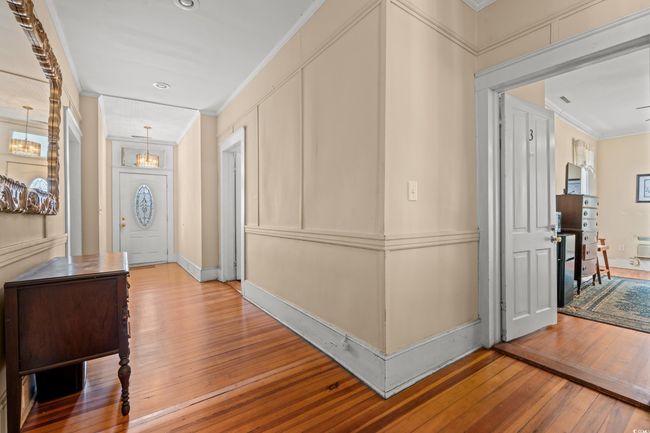 Hallway with wood-type flooring, ornamental molding, a chandelier, and recessed lighting | Image 28