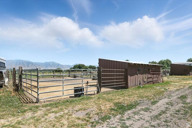 View of yard featuring an exterior structure, a mountain view, an outbuilding, and a rural view | Image 35
