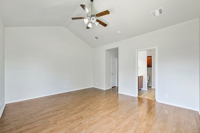 Unfurnished room with ceiling fan, light wood-type flooring, and vaulted ceiling | Image 15