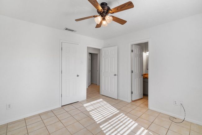 Unfurnished bedroom featuring light tile patterned floors and ceiling fan | Image 15