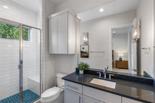 Bathroom 4 en-suite with vanity, a walk-in shower, and recessed lighting. | Image 34