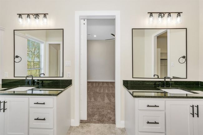 Full bath with two vanities, baseboards, and a sink | Image 22