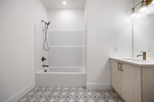 Bathroom with baseboards, shower / bathtub combination, and vanity | Image 17
