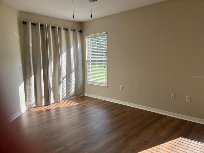 PIMARY BEDROOM WITH SLIDING DOORS TO COVERED PATIO | Image 11