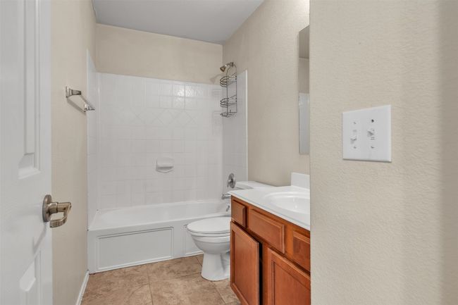Full bathroom upstairs for additional bedrooms with tub | Image 10