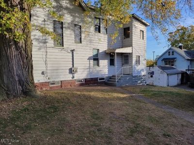 Rear view of property featuring a storage shed | Image 3