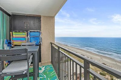 Balcony featuring a view of the beach and a water view | Image 2