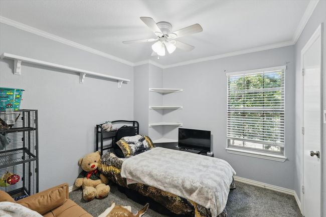 Bedroom featuring carpet, crown molding, and ceiling fan | Image 23