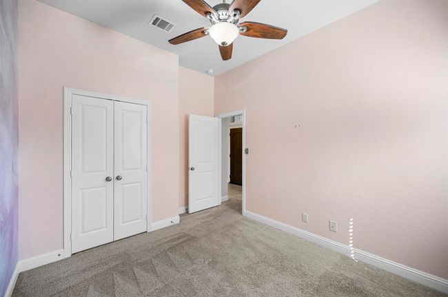 Unfurnished bedroom featuring visible vents, a ceiling fan, a closet, carpet, and baseboards | Image 8