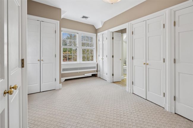 Third Bedroom currently used as a Custom Walk-in Closet featuring built-ins | Image 25