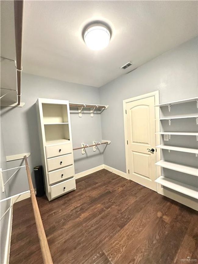 Spacious closet featuring dark wood-type flooring | Image 16