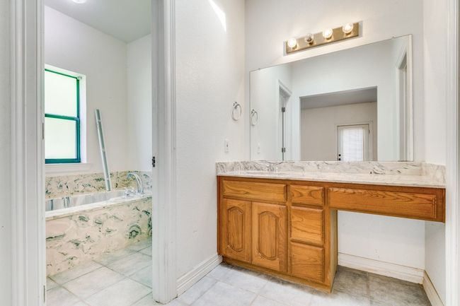 Bathroom with vanity, a garden tub, and tile patterned floors | Image 14