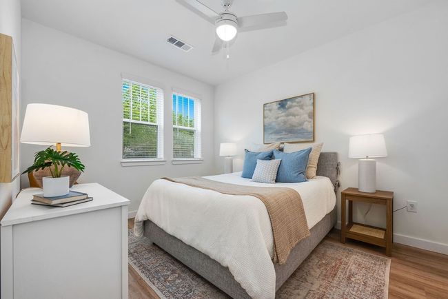 Bedroom with light wood-style floors, baseboards, and a ceiling fan | Image 11