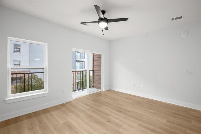 Living room featuring light wood finished floors and a ceiling fan | Image 7