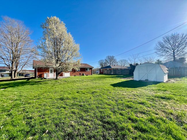 view of yard with a shed, fence, and an outbuilding | Image 26