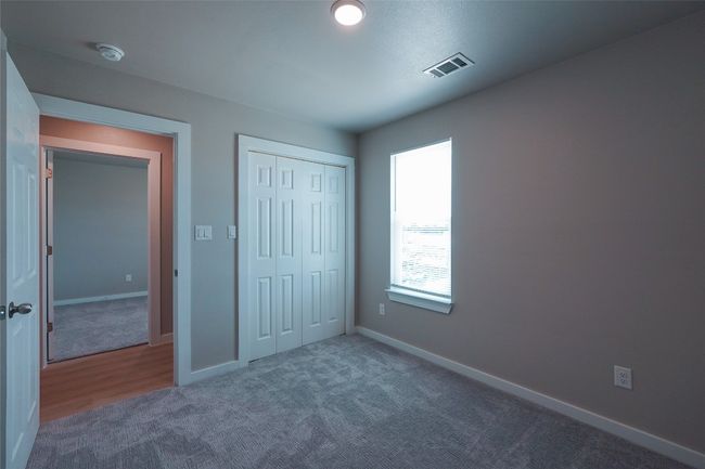 Unfurnished bedroom with carpet and a closet | Image 23