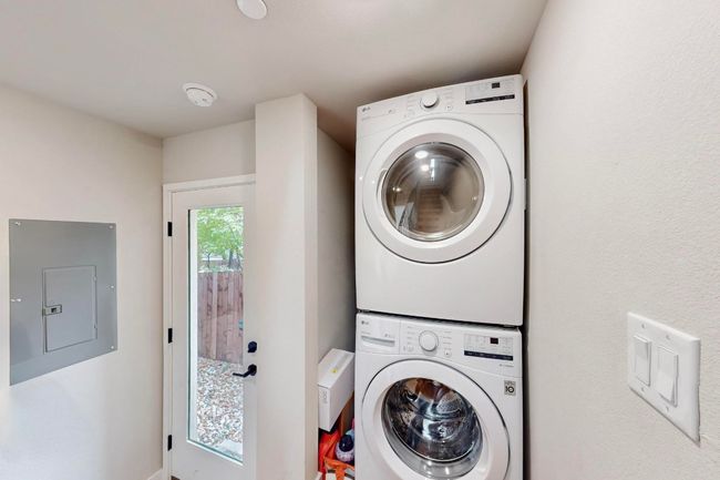 Washroom with electric panel and stacked washer / dryer | Image 25