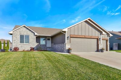 View of front facade with a garage and a front lawn | Image 2