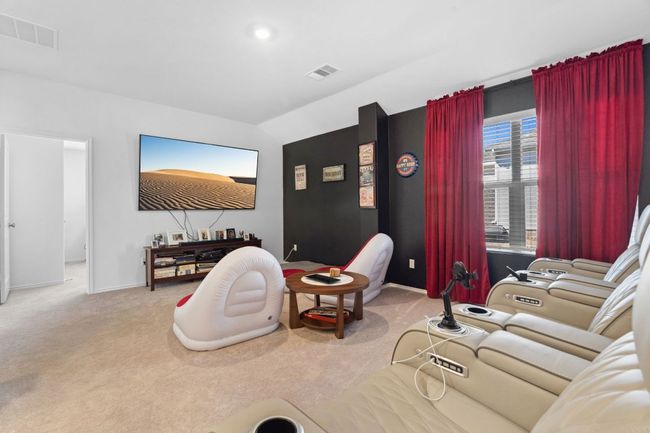 Living area with baseboards, visible vents, and light colored carpet | Image 22