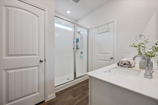 Bathroom with a stall shower, wood finished floors, and vanity | Image 34