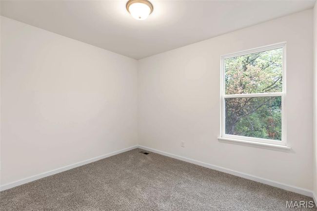 Carpeted spare room with baseboards | Image 21