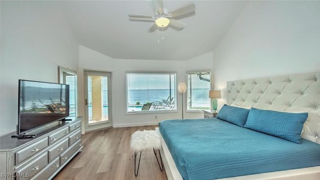 Master Bedroom featuring vaulted ceiling, light wood-type flooring, a ceiling fan, and access to outside | Image 18
