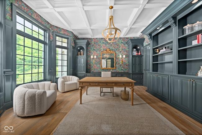 home office with wallpapered walls, wood-type flooring, a chandelier, coffered ceiling, and beamed ceiling | Image 37