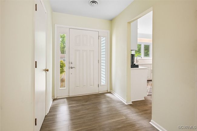 Entryway with dark wood-style flooring and baseboards | Image 4