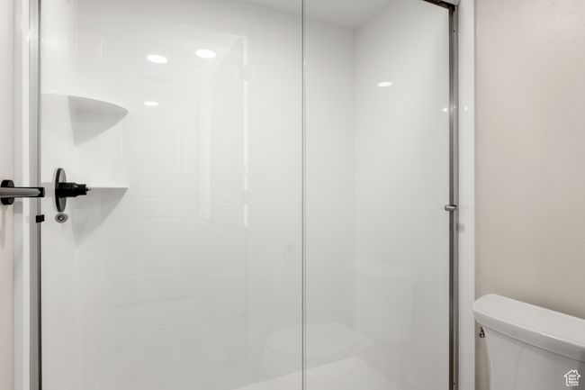 Bathroom featuring toilet and a shower stall | Image 21