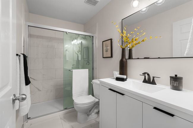 Bathroom with vanity, marble finish floors, toilet, and a shower stall | Image 20