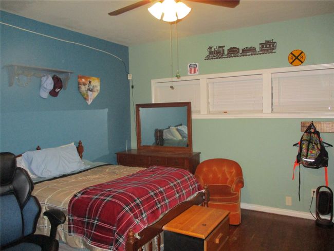 Bedroom featuring ceiling fan and hardwood / wood-style flooring | Image 27