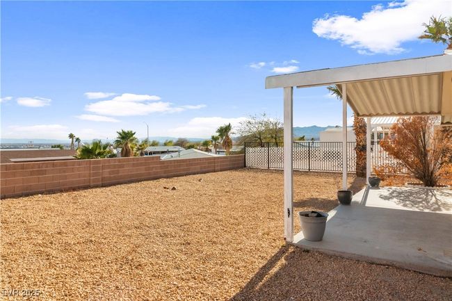 View of yard with a patio area, a fenced backyard, and a mountain view | Image 35