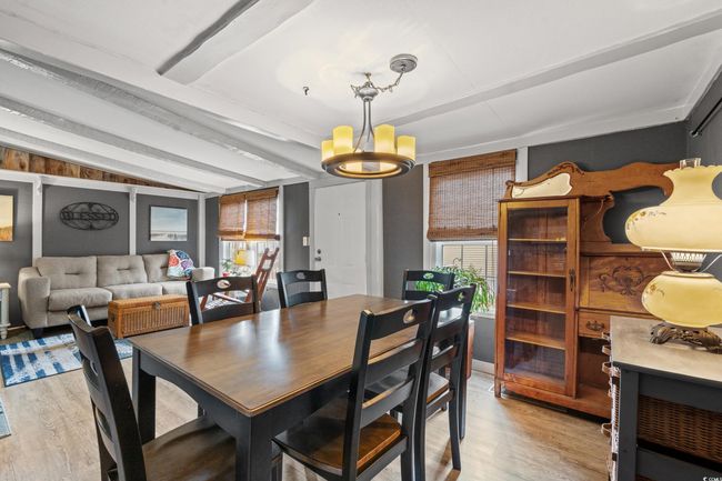 Dining space featuring a chandelier, lofted ceiling with beams, and light hardwood / wood-style floors | Image 10