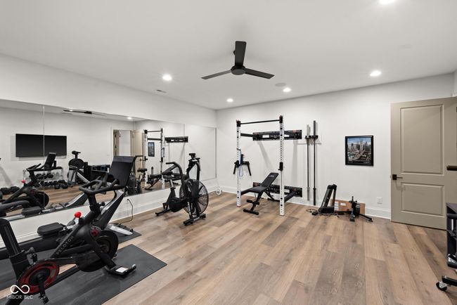 workout room featuring a ceiling fan, light wood-type flooring, recessed lighting, and baseboards | Image 88