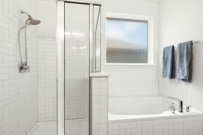 Tub and shower with natural light and basketweave tile detailing | Image 13