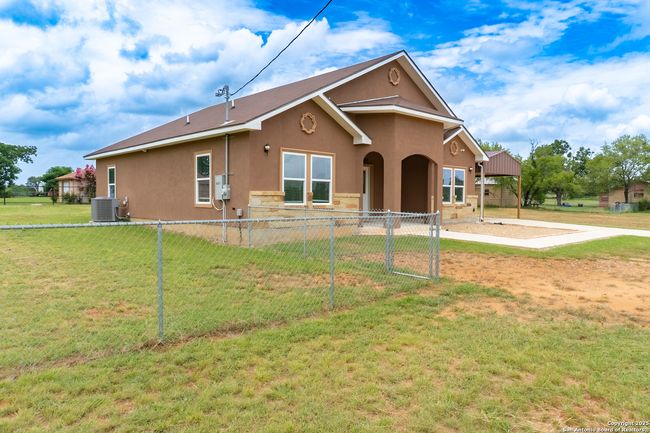 Side view showcases fenced yard and home exterior | Image 4