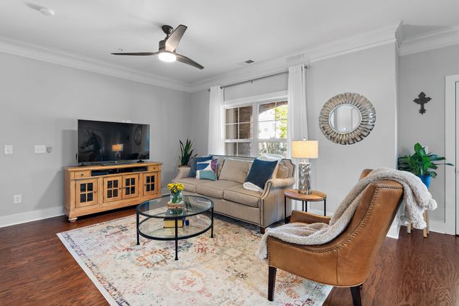 The living room is a bright, welcoming space that's sure to make a great first impression on guests! | Image 4