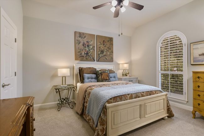 UPSTAIRS Bedroom with light carpet, ceiling fan, and DOUBLE closets back-to -back. | Image 24