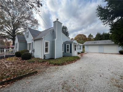 View of side of property with an outdoor structure and a garage | Image 3