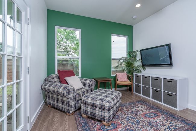 Living area featuring baseboards, wood finished floors, and recessed lighting. | Image 27
