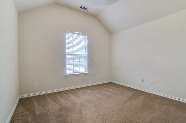 Carpeted second guest bedroom featuring lofted ceiling and baseboards | Image 20