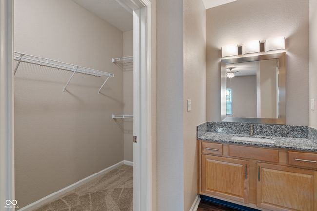Primary Bedroom walk in closet and private sink and vanity | Image 21