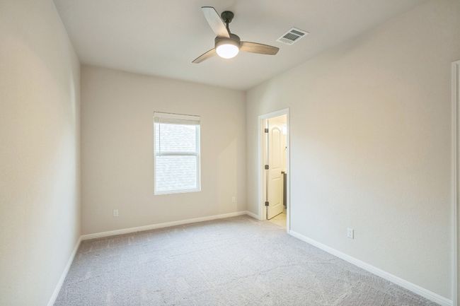 Spare room featuring light colored carpet, a ceiling fan, and baseboards | Image 16