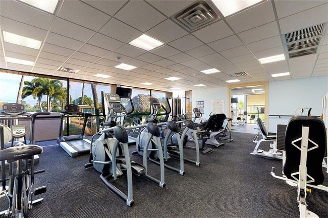 Exercise room featuring a paneled ceiling, visible vents, and plenty of natural light | Image 48
