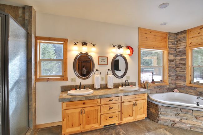 Bathroom with plenty of natural light, a garden tub, and a sink | Image 16
