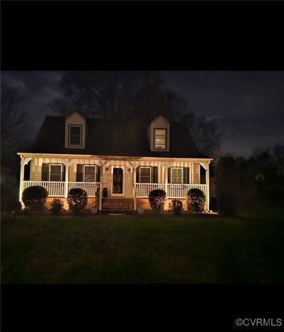 New england style home with a porch and a yard | Image 3